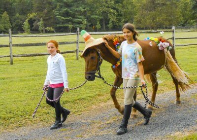 Girls Walking Horse
